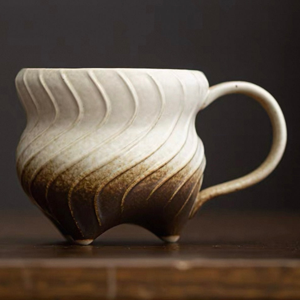 Three-legged ceramic cup