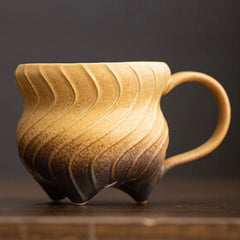Three-legged ceramic cup
